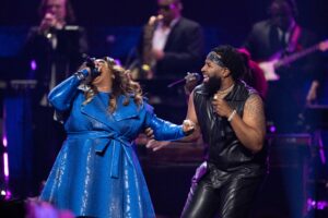 Pastor Mike, Jr. and Kierra Sheard Kelly perform on the show